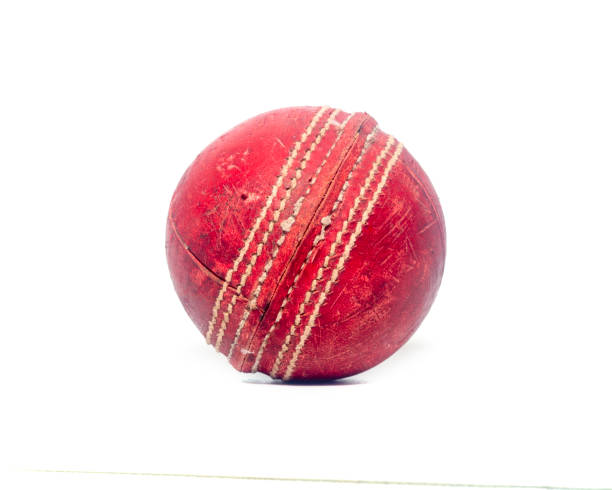 istock Old red leather cricket ball isolated against a white background 1303400113