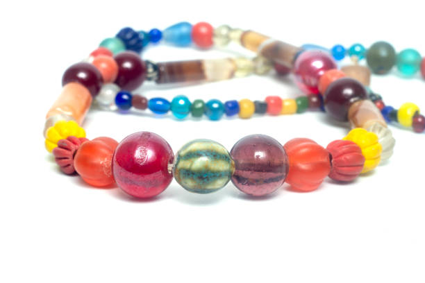 istock Ancient beads multicolored Thailand isolated on white background. 1303400212