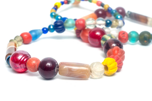 istock Ancient beads multicolored Thailand isolated on white background. 1303400218