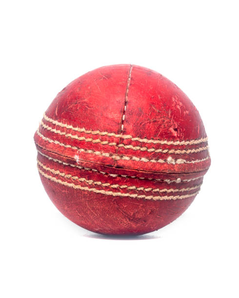 istock Old red leather cricket ball isolated against a white background 1303400260