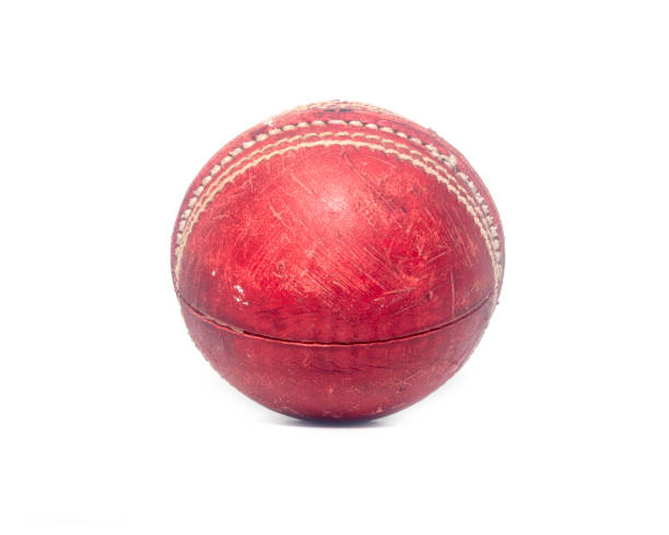 istock Old red leather cricket ball isolated against a white background 1303400268