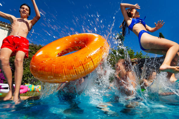 istock Kids dive with inflatable doughnut to the pool 1303401889