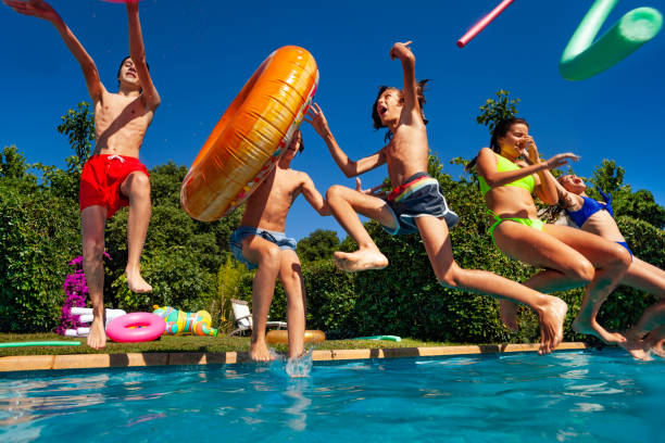 istock Group kids dive in water throwing inflatable toys 1303401892