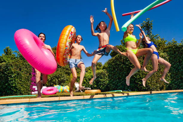 istock Many kids dive in water throwing inflatable toys 1303401896