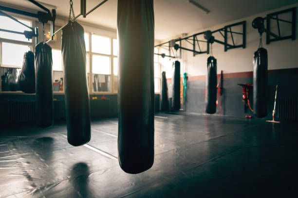 istock Empty gym room with heavy bags 1303402106