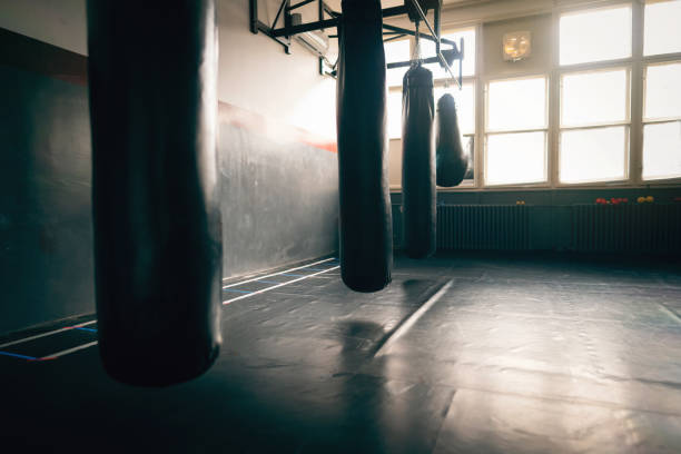 istock Empty gym room with heavy bags 1303402110