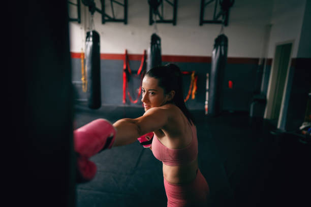 istock Young fit woman direct punch a heavy bag 1303402119