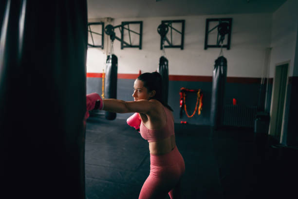 Young fit woman direct punch a heavy bag