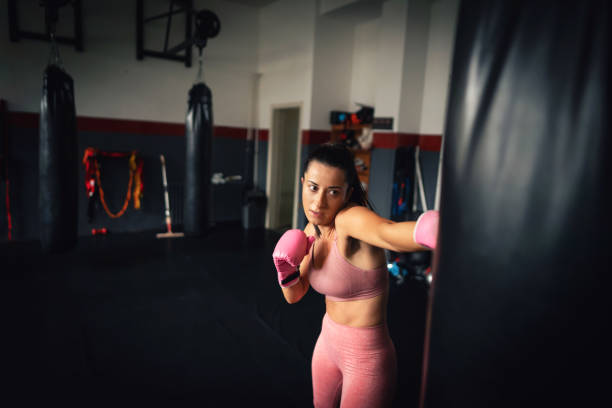istock Young fit woman direct punch a heavy bag 1303402122
