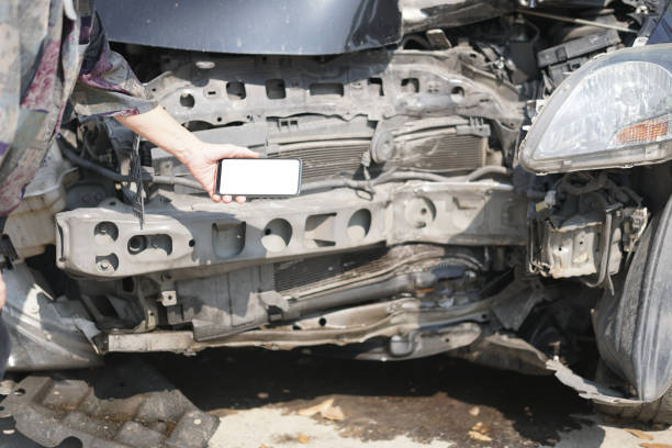 istock hand take photo of crashed damaged broken car. automobile crash accident 1303404402