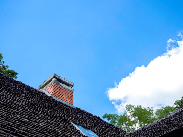 istock Brick chimney on the old roof. 1303408347