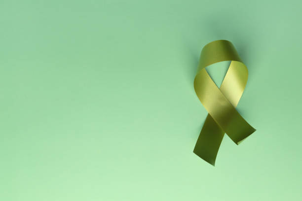istock A green awareness ribbon on green background 1303408349