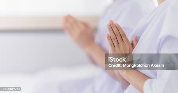 Hands Of Religious Asian Buddhist People In White Cloth Praying And Chanting Stock Photo - Download Image Now