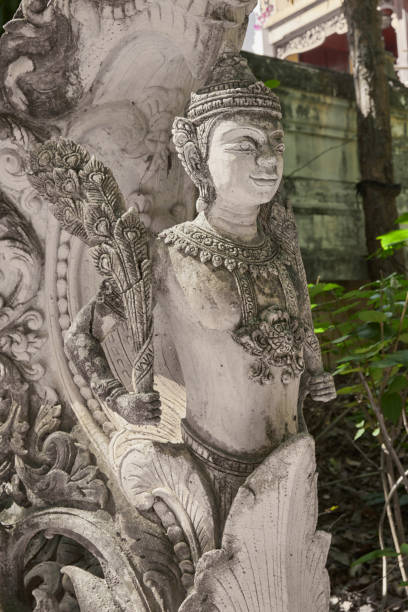 Phayao, Thailand - Nov 22, 2020: Portrait Right View Stone God Statue in Analayo Temple or Wat Analayo on Blurring Background