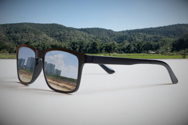 istock Abstract illustrations reflect the vision of a real estate developer.By reflecting the image of tall building construction through eyeglass lenses that see an undeveloped area. 1303410241