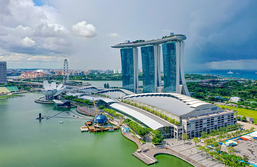 Singapore, June 14, 2019. Aerial view of the famous landmark, Marina Bay Sands in Singapore seen a sunny day. The hotel is shaped like a boat with a large infinity pool on the roof.