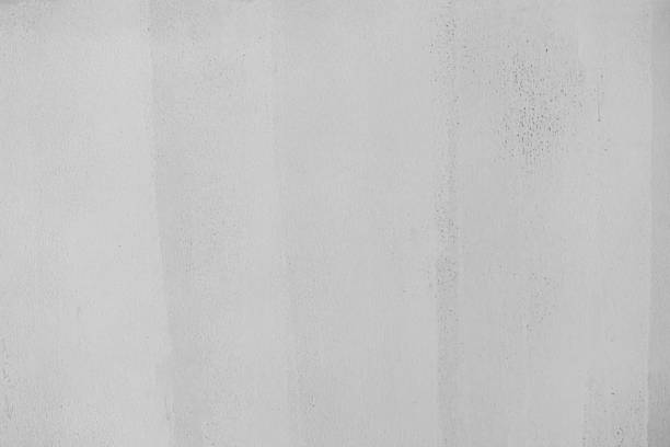 istock Coarse cement plaster wall for white background, rough textured background, black and white for the old white retro wall background for the background, can be beautifully assembled into the decoration 1303414581