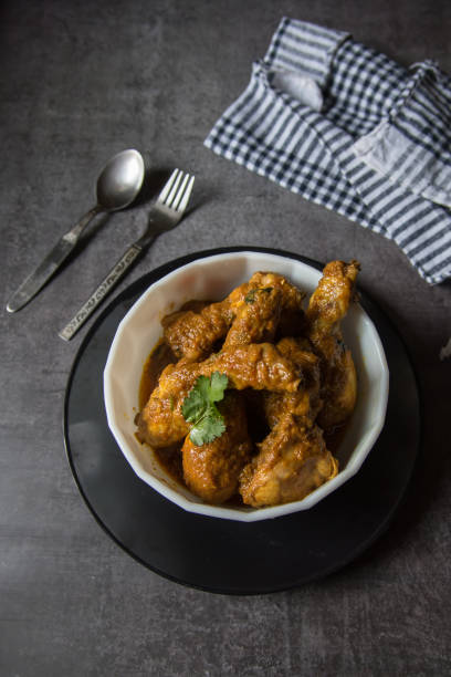 istock Spicy chicken in gravy in a bowl. 1303419321
