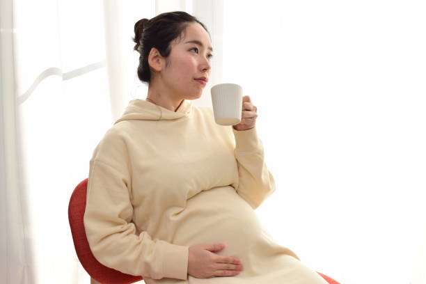 istock pregnant woman with a mug 1303420287