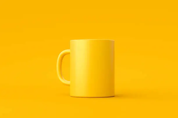 Photo of Yellow coffee cup or empty mug for drink on vivid color background with blank ceramic porcelain mockup template. 3D rendering.
