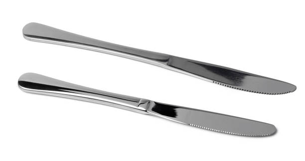 istock Set of silver dining knives isolated on white 1303422843