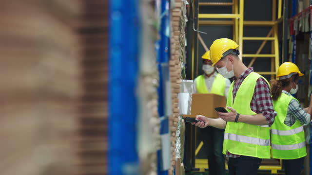 4k footage of Workers scanning and checking goods stock on shelf in warehouse inventory
