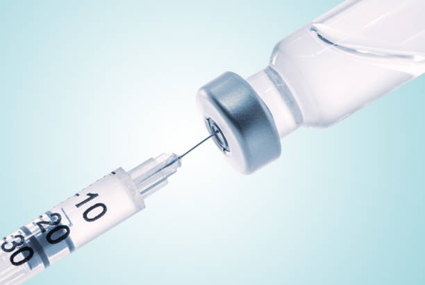 istock Taking vaccine with syringe from ampule 1303424405