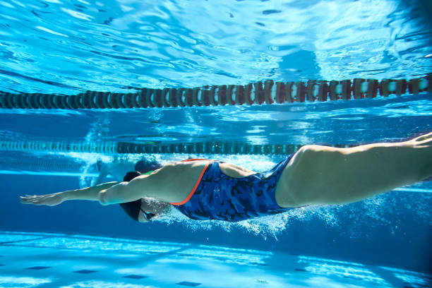 istock Adaptive Athlete swimmer underwater after diving in. 1303424409