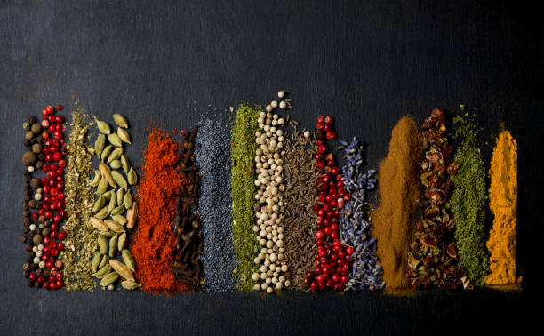 istock Various spices spoons on black table. Top view with copy space 1303426056