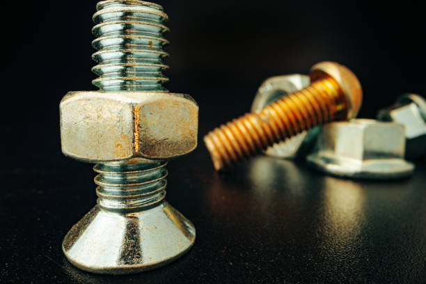 istock Metal screws and nuts on black background 1303426418
