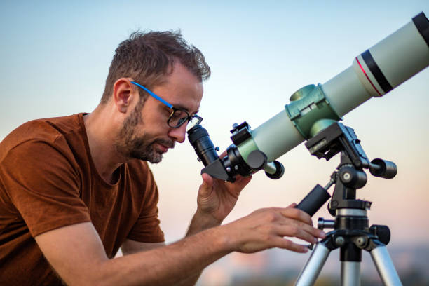 istock Amateur astronomer looking at the sky with a telescope. 1303427029