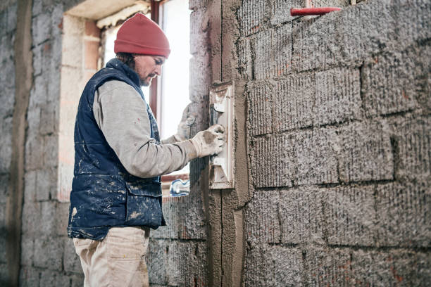 istock Real construction worker working on a wall inside the new house. 1303427405