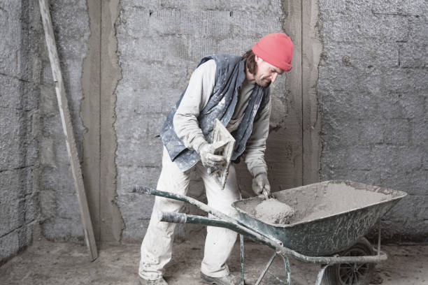 istock Real construction worker working on a wall inside the new house. 1303427912