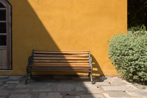 istock Wooden bench chair exterior with light shade 1303429253