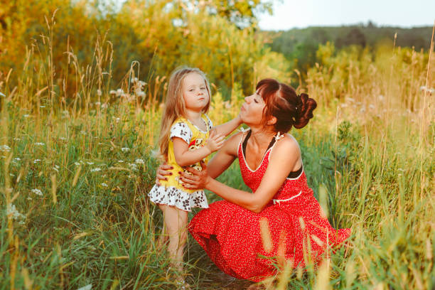 istock mother sitting on the grass with children 1303429811