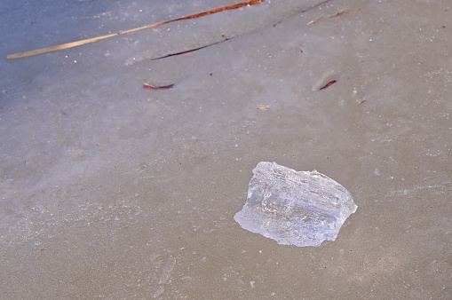 a block of ice on the frozen surface of the lake