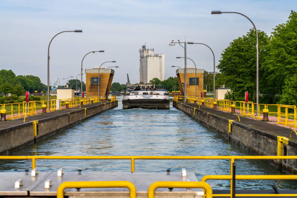 Dorsten, North Rhine-Westphalia, Germany - May 07, 2020: A freight ship on the Wesel-Datteln Canal, leaving the Dorsten sluice