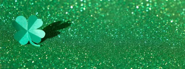 St.Patrick's Day shamrock on glitter background with trendy shadow