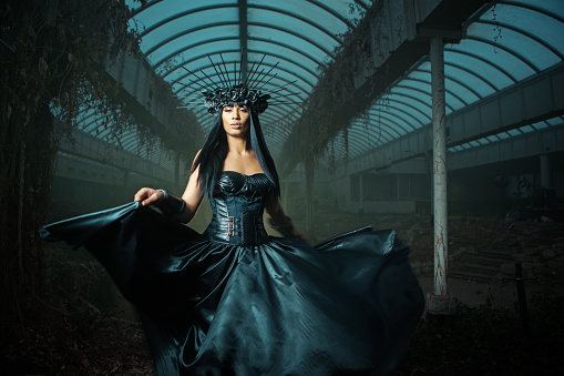 A mixed race individual dark fairytale warrior princess indoors