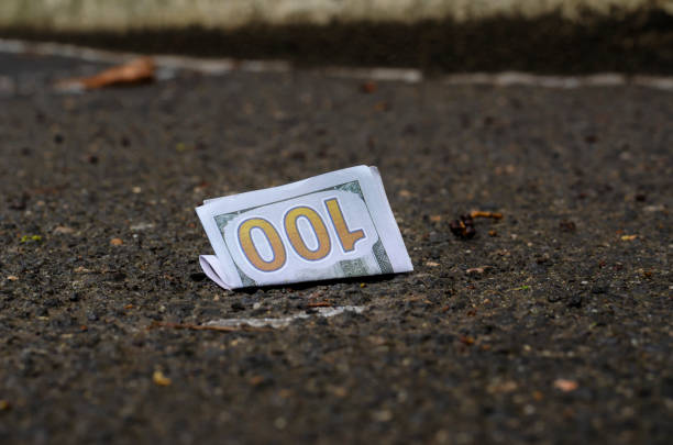 a crumpled one hundred dollars bill lies on the asphalt. - crumpled currency dollar folded imagens e fotografias de stock