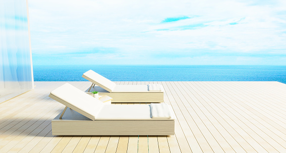 Minimal Luxury beach house with sea view on terrace modern design, Sunbed Lounge chairs on deck at vacation home or hotel . 3d rendering. illustration of summer holiday Pool villa exterior.