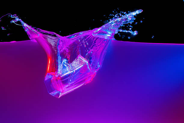 istock Perfume bottle diving into the water with a splash in neon light 1303437788