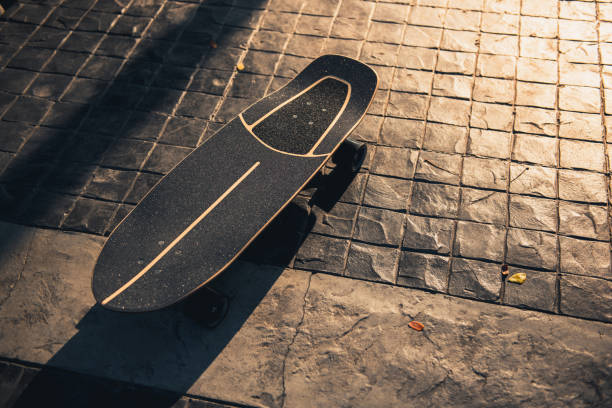 istock Close up surf skate or skateboard at park sunset 1303438747