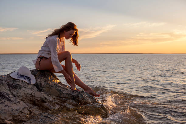 istock Beautiful woman enjoying sunset on the beach. 1303440219