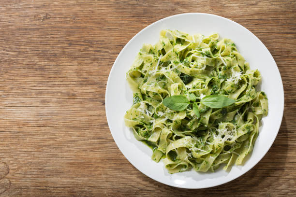 istock plate of pasta with pesto sauce, top view 1303442536