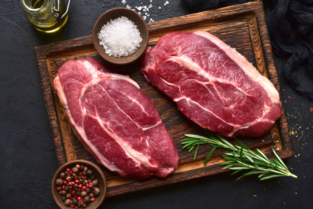 istock Raw organic marbled beef steaks with spices 1303444788
