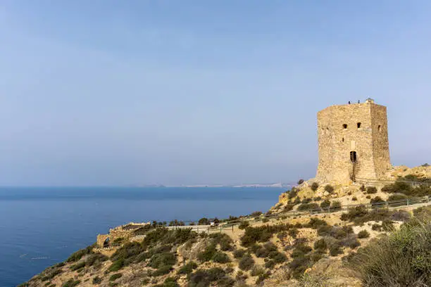 A view of the Torre de Santa Elena watchtower above the town of la Azohia in Murcia