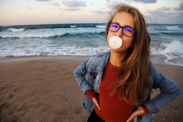 istock Blowing bubble gum on the beach 1303449492