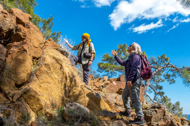 istock An elderly couple with a backpacking hiker exploring nature with admiration 1303450553
