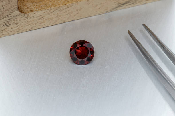 istock macro mineral faceted stone cut Garnet on a gray background 1303451753